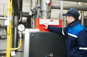 heating engineer repairman in boiler room