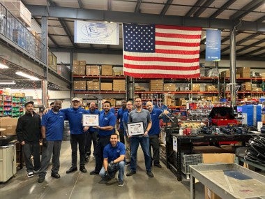 Shipping staff with award